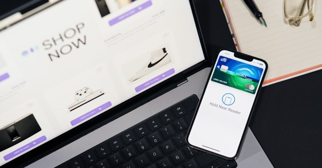 Laptop showing e-commerce site with a smartphone for mobile payment. Ideal for tech and shopping themes.